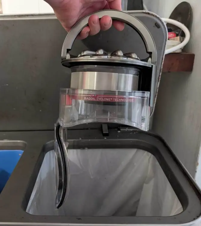 Dyson canister being emptied
