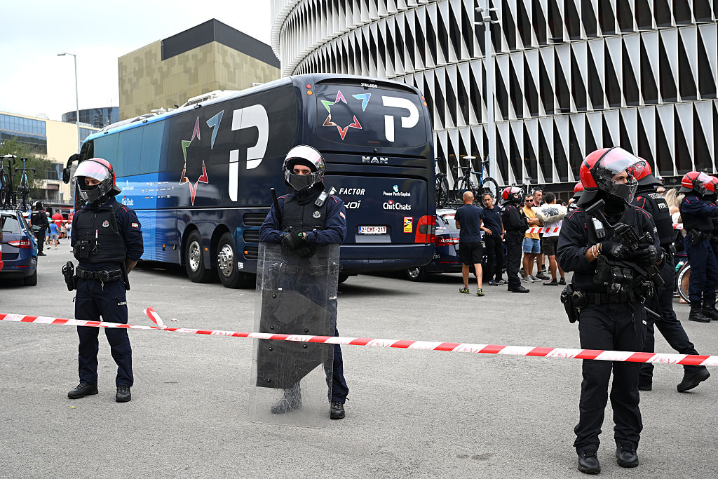 Police guard the Israel–Premier Tech team bus at La Vuelta.