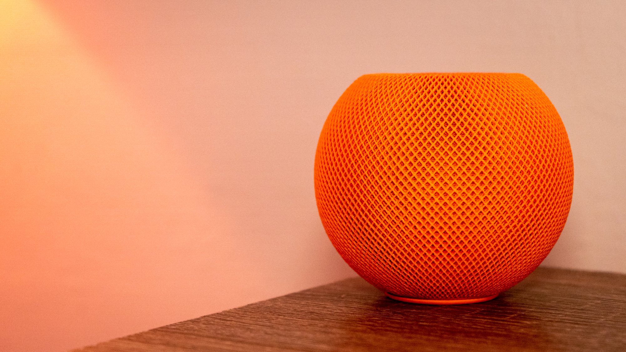 a photo of the apple homepod mini in orange