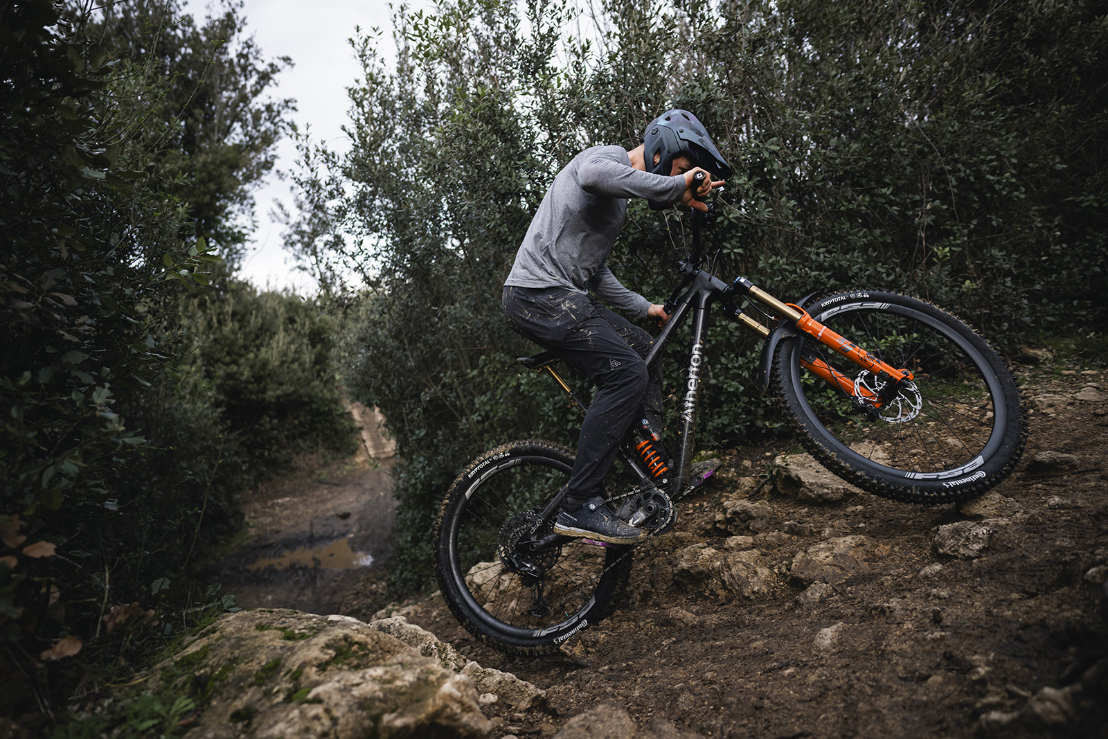 Male rider in grey top riding the Atherton A.170.1 full suspension mountain bike