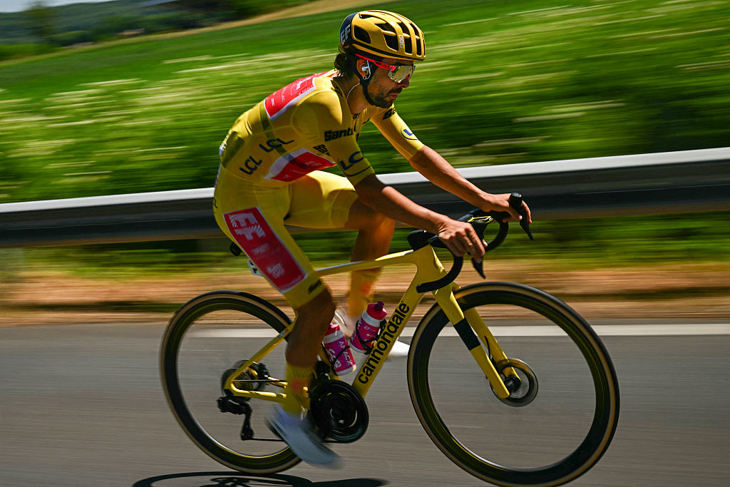 EF Education - EasyPost team's Irish rider Ben Healy wearing the overall leader's yellow jersey cycles with the pack of riders (peloton) during the 12th stage of the 112th edition of the Tour de France cycling race, 180.6 km between Auch and Hautacam, in the Pyrenees mountains of southwestern France, on July 17, 2025. (Photo by Loic VENANCE / AFP) (Photo by LOIC VENANCE/AFP via Getty Images)