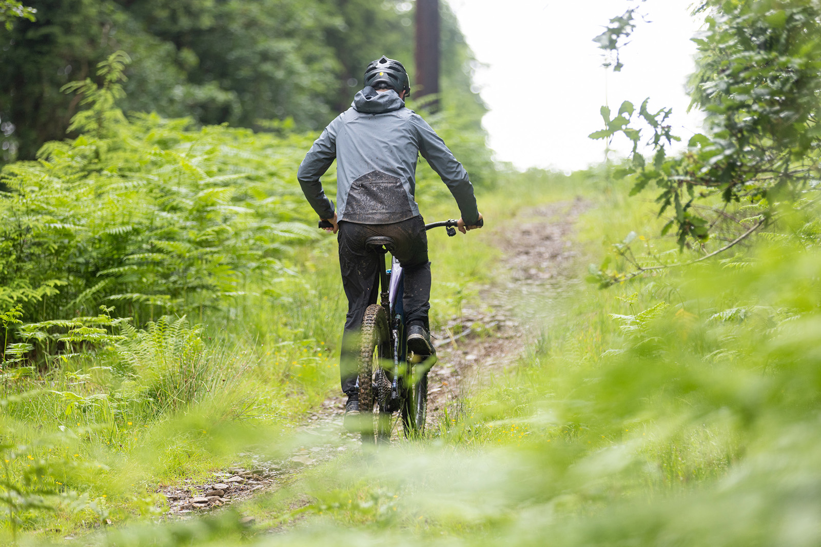 Male cyclists in grey top riding the Whyte Kado RSX full suspension electric mountain bike - eMTB