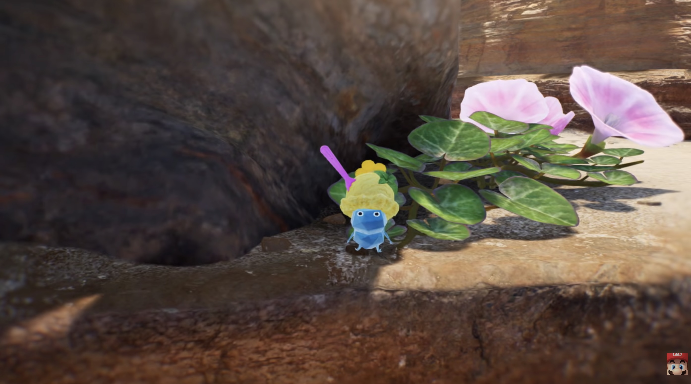 An Ice Pikmin with a scoop of vanilla ice cream on its head and a pink spoon sticking out sits on a rocky ledge