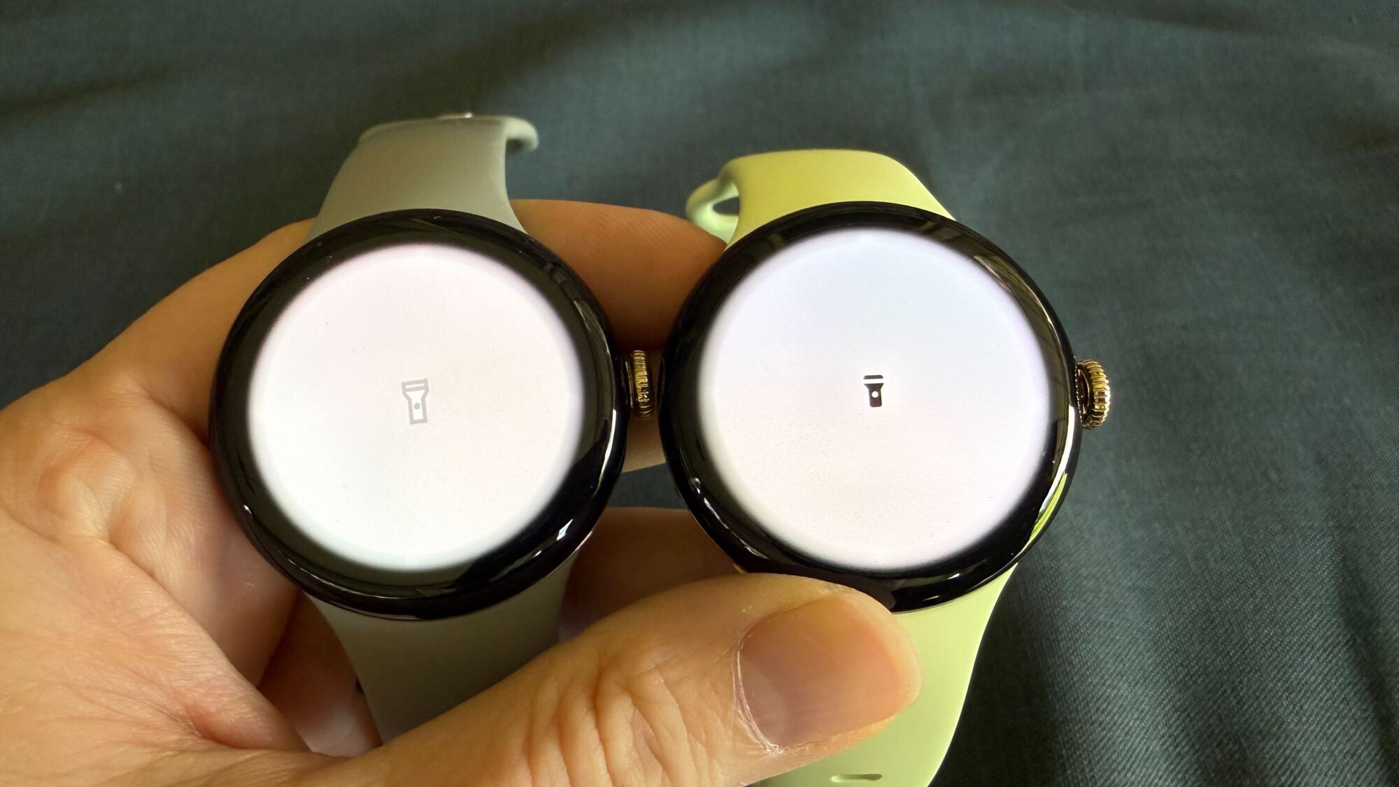 Both watches showing a white screen (flashlight app)