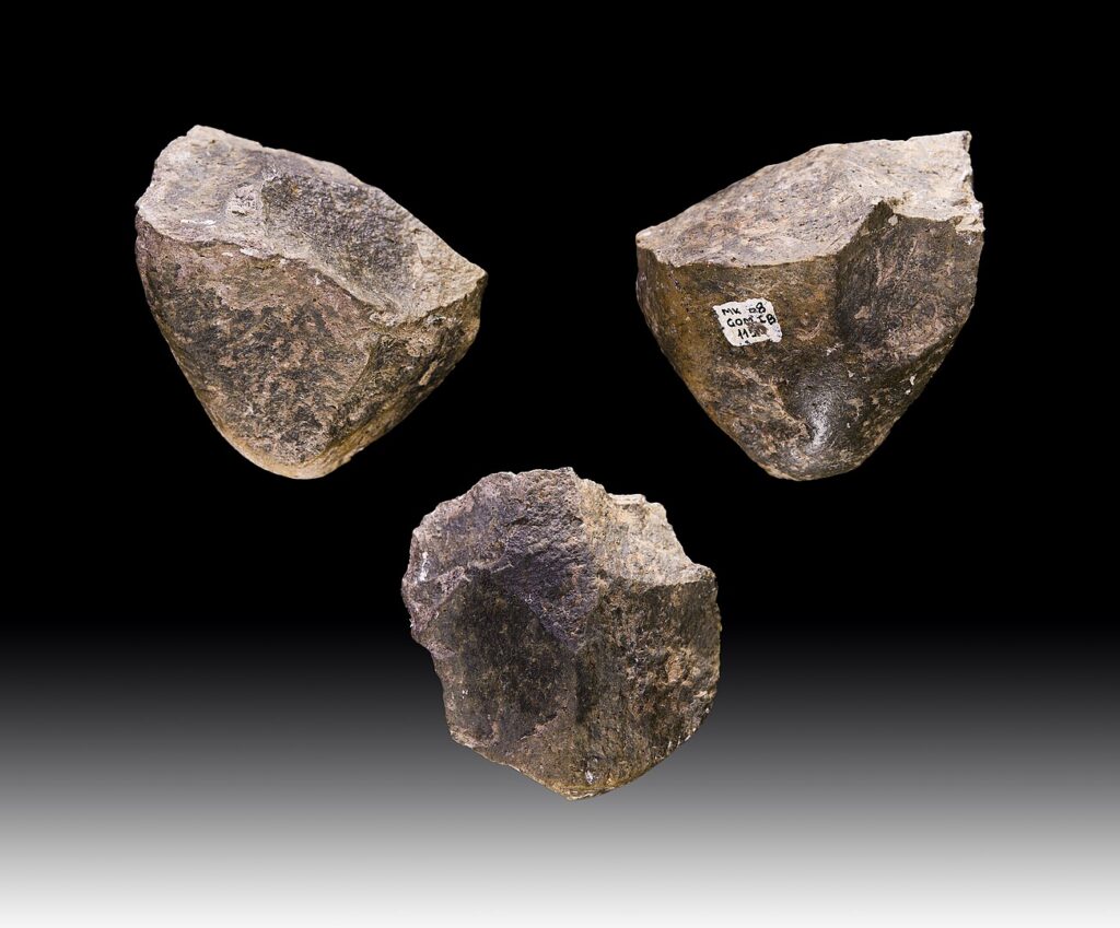 Photo of 3 chunks of stone with flakes chipped off to make sharp edges