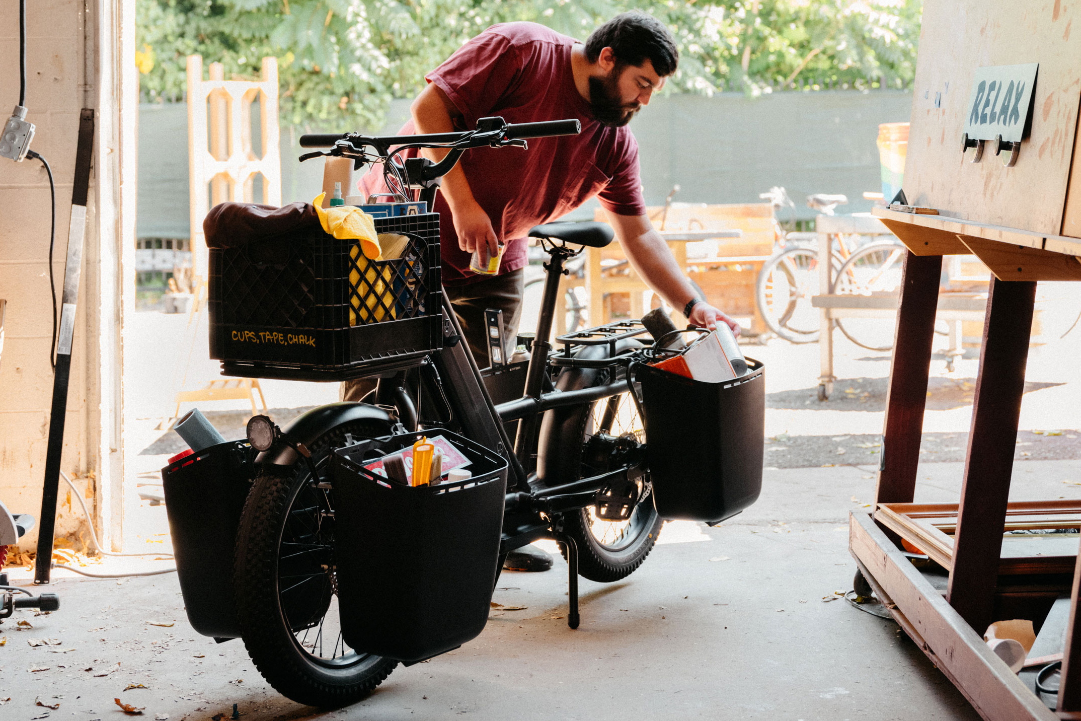 Man loading up panniers on Globe Haul LT electric cargo bike