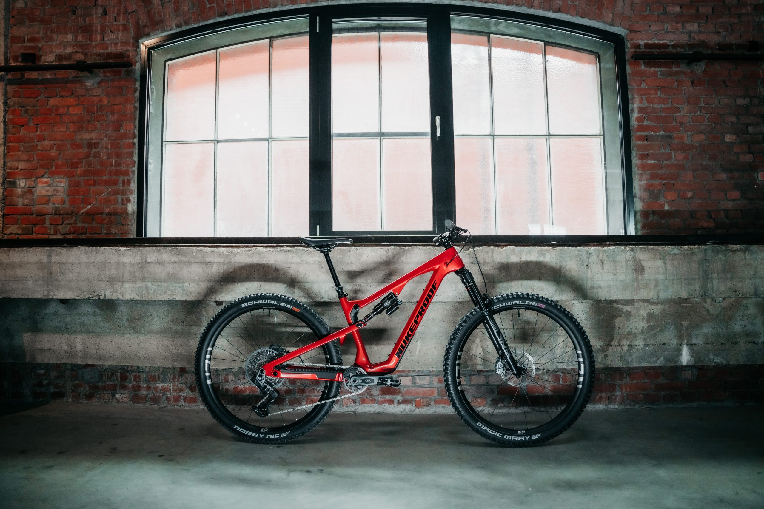 Nukeproof Reactor Carbon Pro 290 side-on shot in disused warehouse.