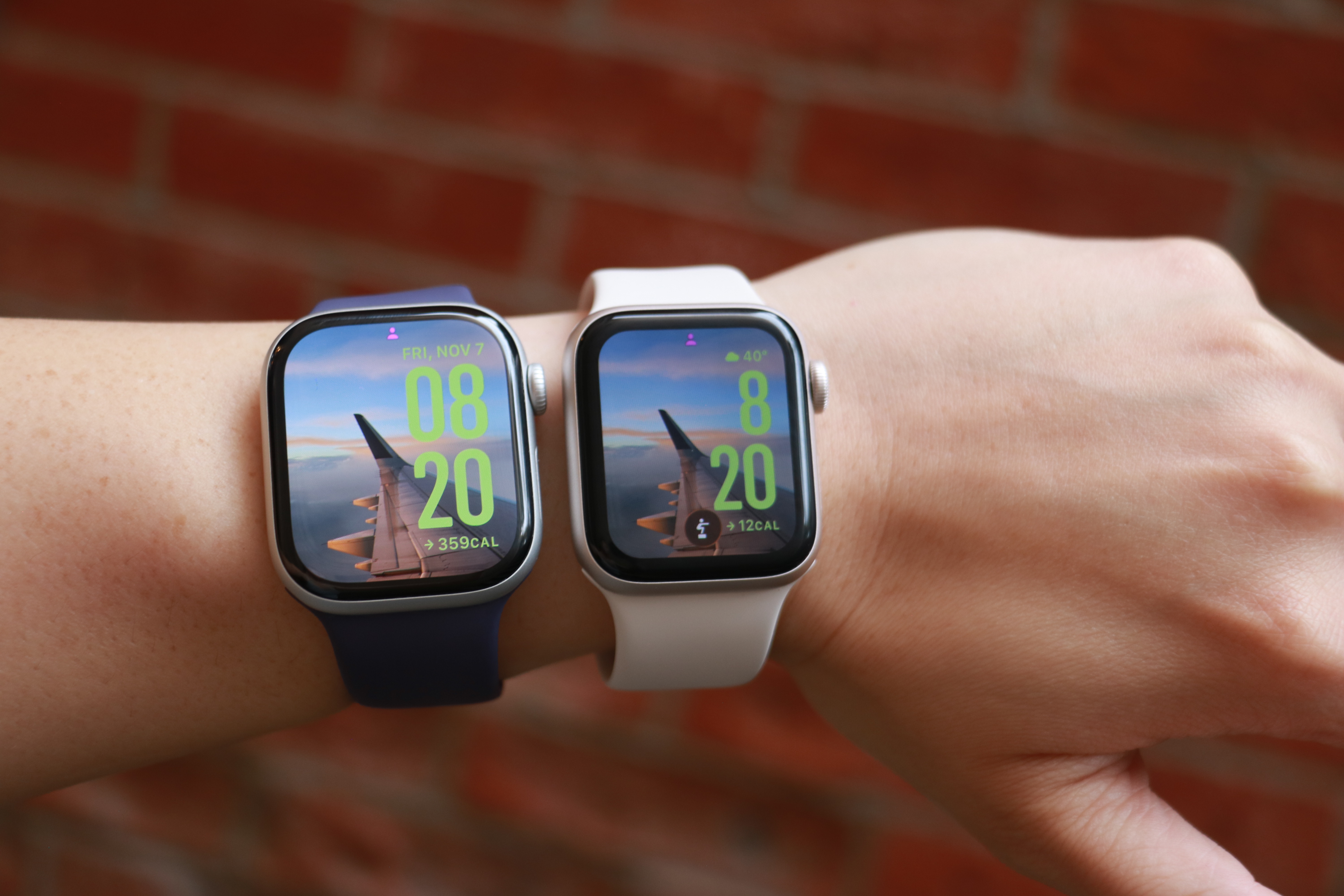 The Apple Watch Series 11 and Apple Watch SE 3 side by side on the same forearm.