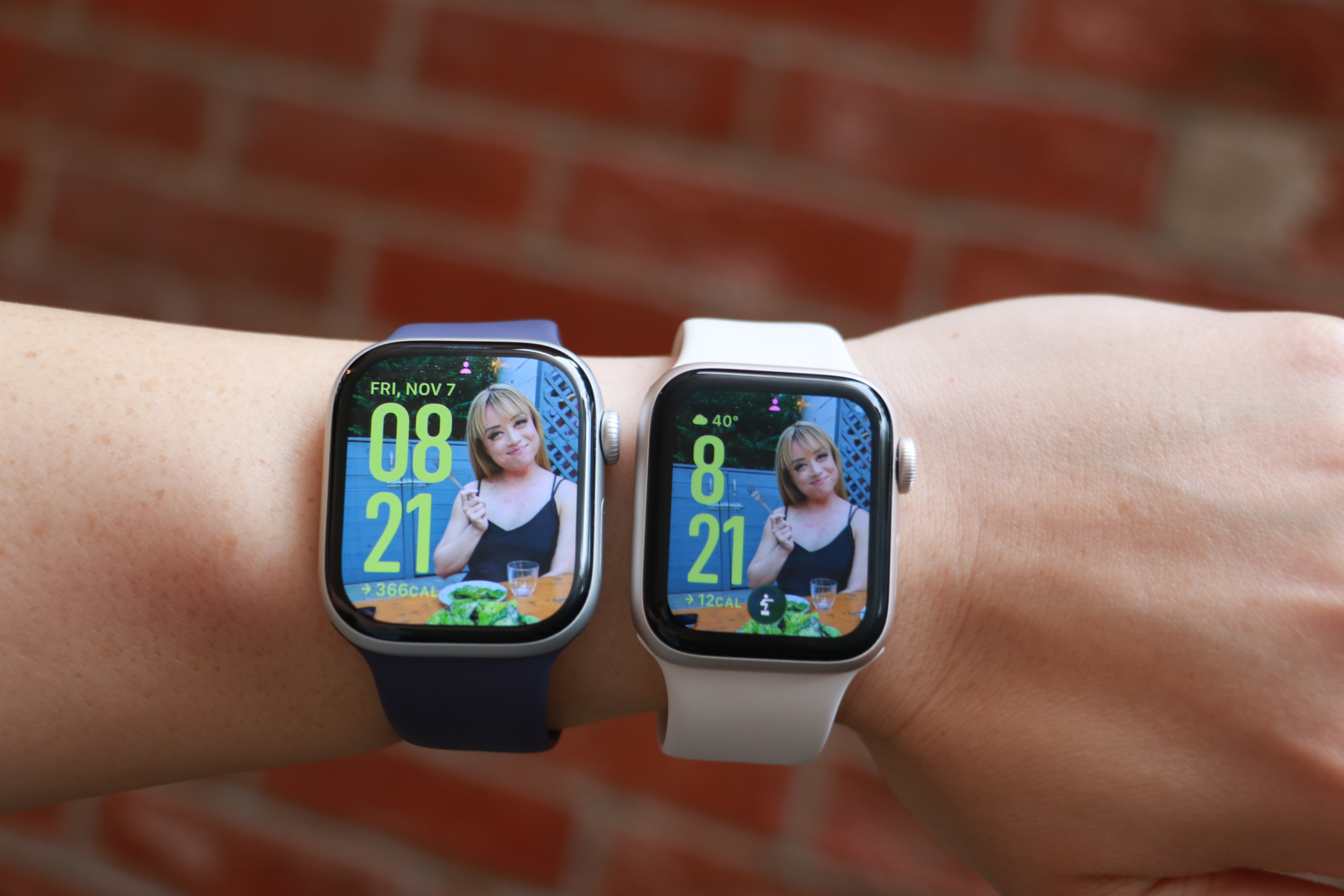 The Apple Watch Series 11 and Apple Watch SE 3 side by side on the same forearm, with the same photo watch face on their screens. 