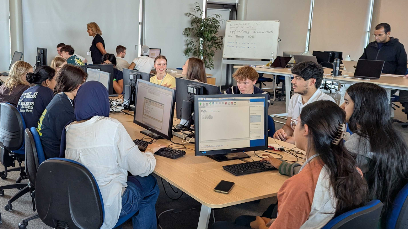 Photo of a class of students at computers, in a computer science classroom.