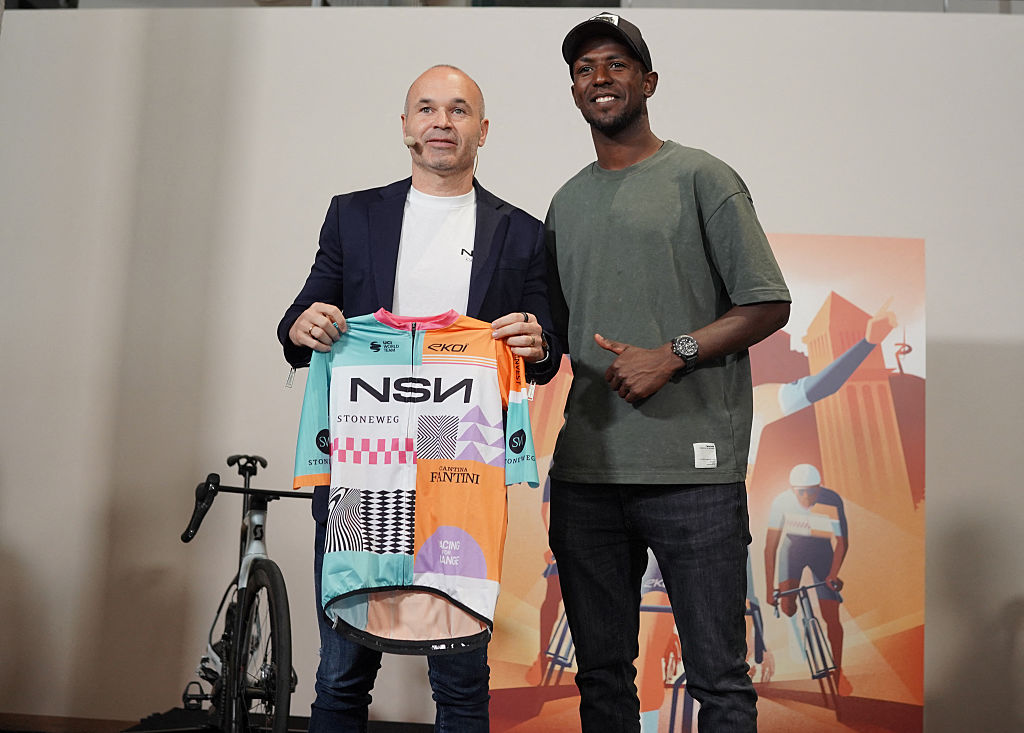 NSN co-founder former Spain and Barcelona football star Andres Iniesta and Erythrean cyclist Binian Girmay (R) attend the official presentation of the NSN cycling team - ex Israel-Premier Tech - in Barcelona on December 9, 2025. Iniesta is a co-founder of sports and entertainment agency NSN, which partnered with Swiss global investment platform Stoneweg, took over Israel-Premier Tech team in November. IPT's presence at the Vuelta a Espana this year was heavily protested by pro-Palestinian supporters, with several stages of the race heavily disrupted. (Photo by Manaure Quintero / AFP via Getty Images)
