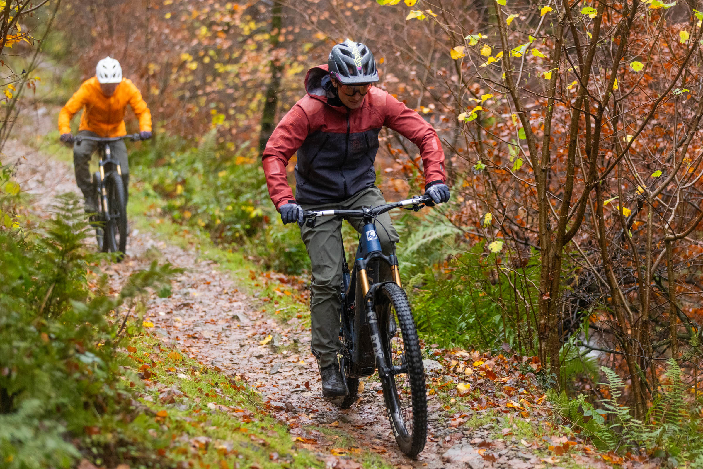 Pivot Shuttle AM and DJI Amflow electric mountain bikes ridden by two male mountain bikers