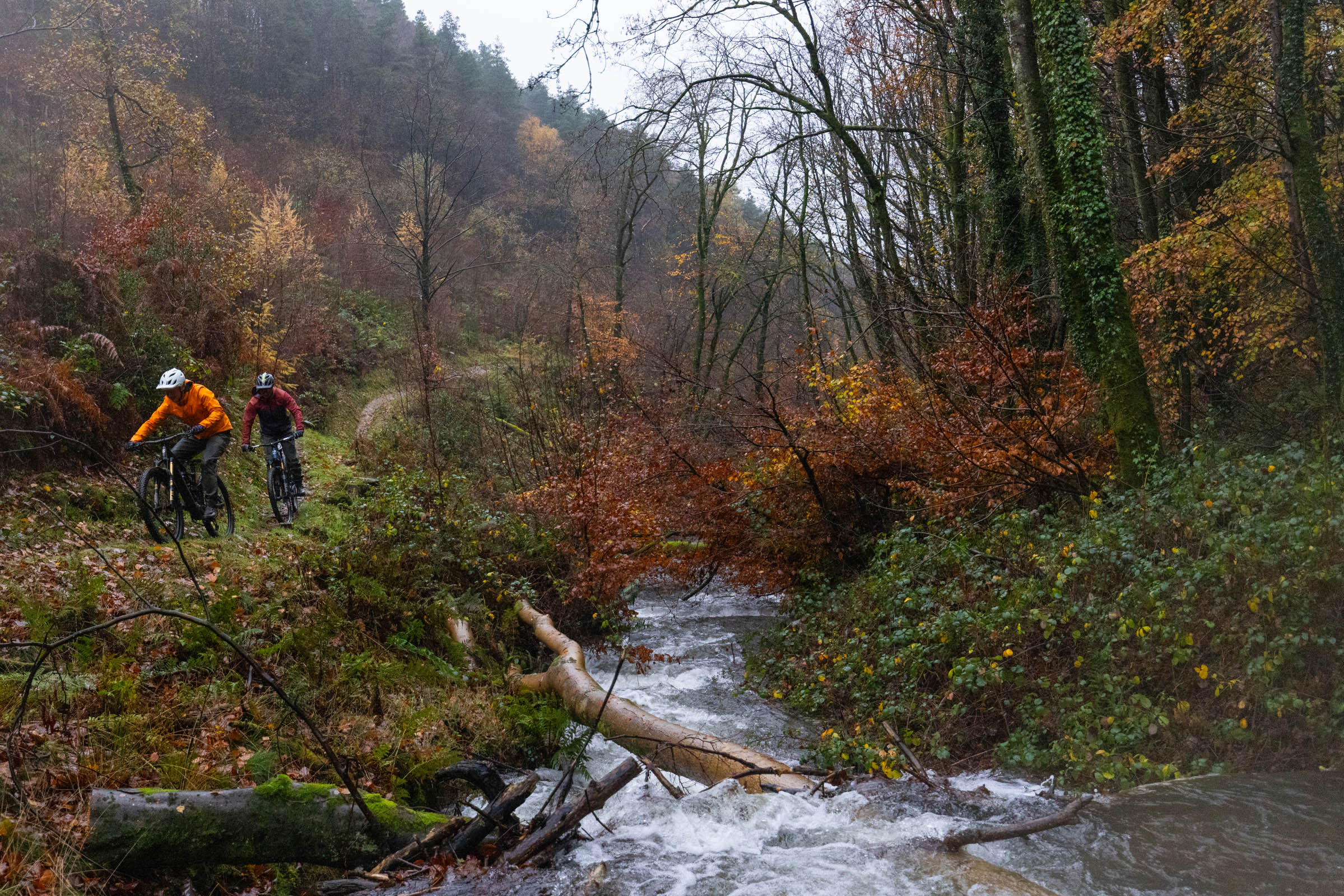 Pivot Shuttle AM and DJI Amflow electric mountain bikes ridden by two male mountain bikers
