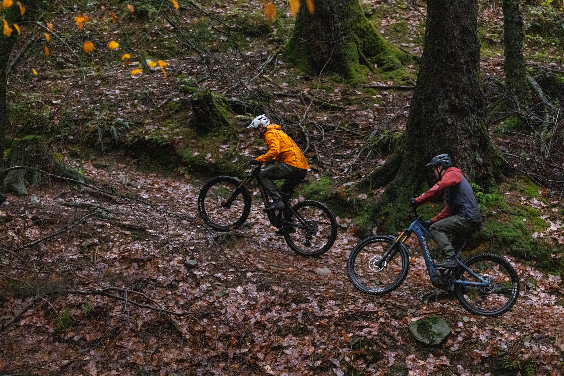 Pivot Shuttle AM and DJI Amflow electric mountain bikes ridden by two male mountain bikers