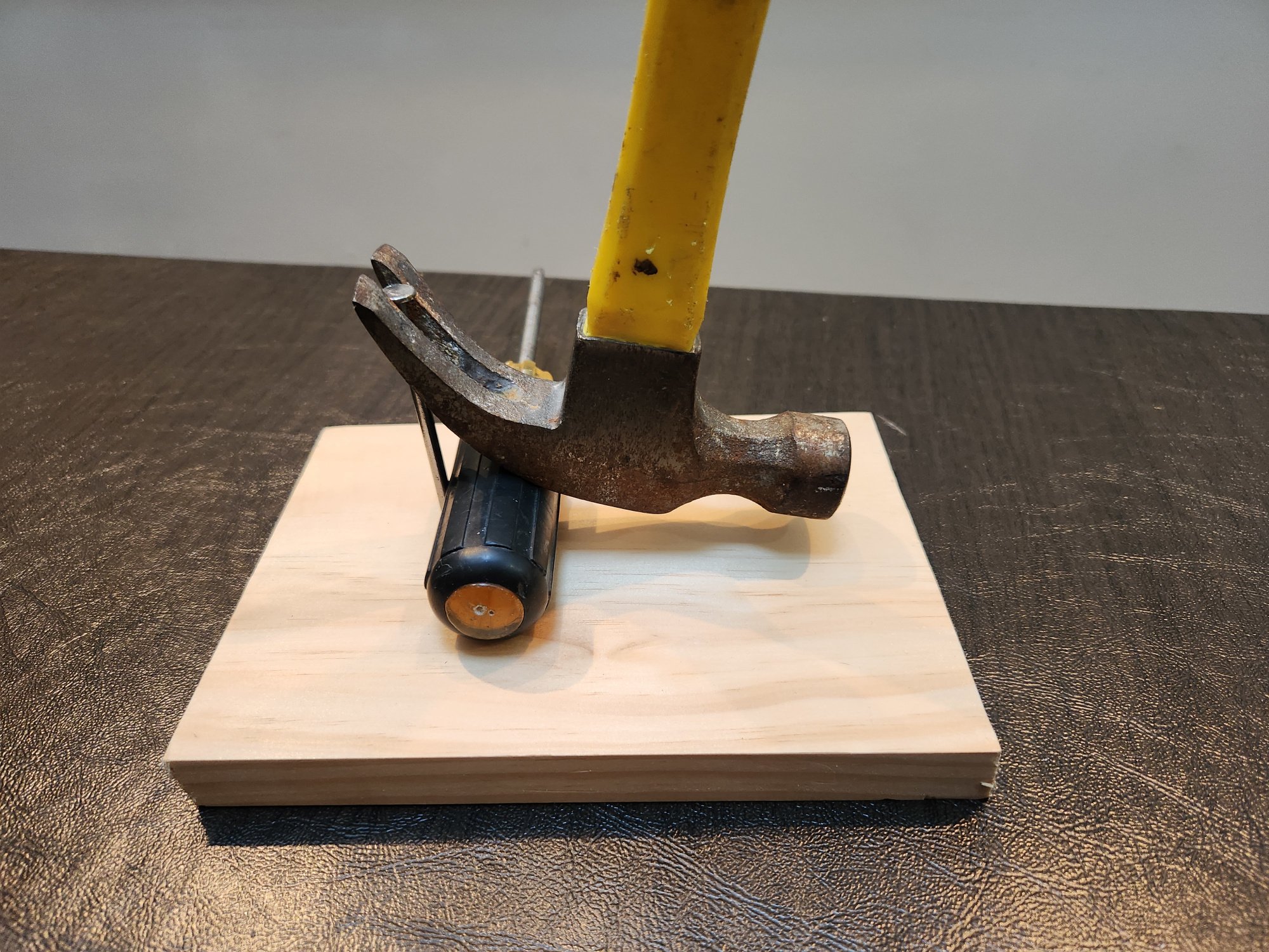 Hammer and screwdriver extracting nail