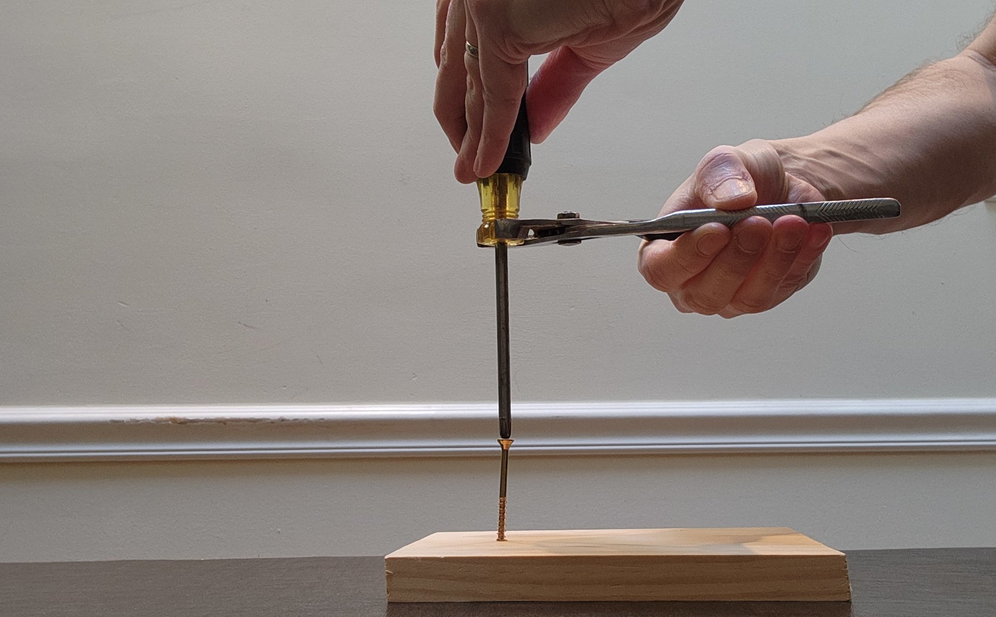 Screwdriver and pliers extracting screw