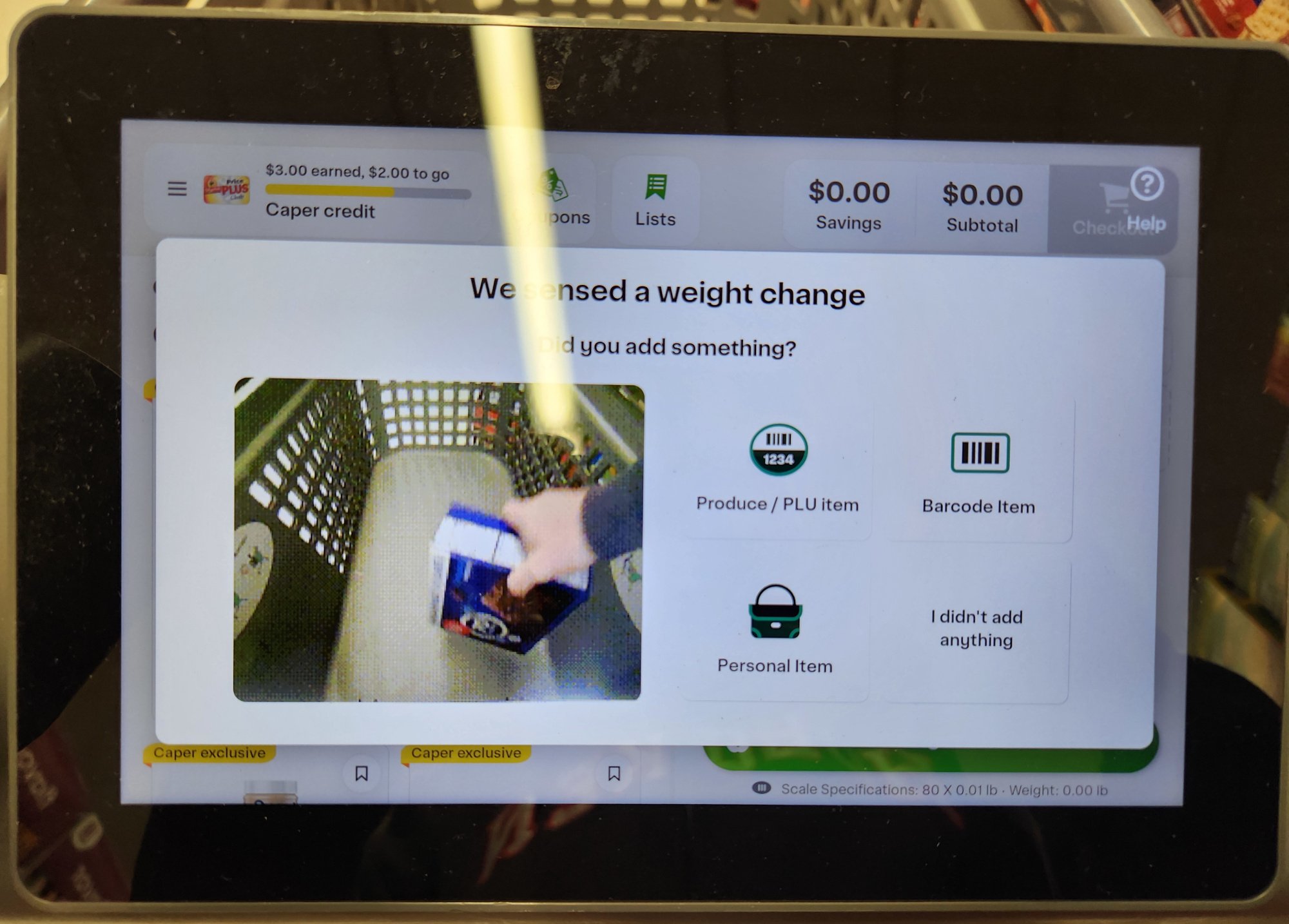 A video pops up if you try putting an un-scanned item in the cart