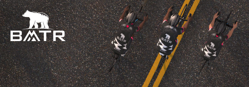 Top-down view of three cyclists in matching black BMTR jerseys riding on a road, with the BMTR logo featuring a bear on the left side of the image.