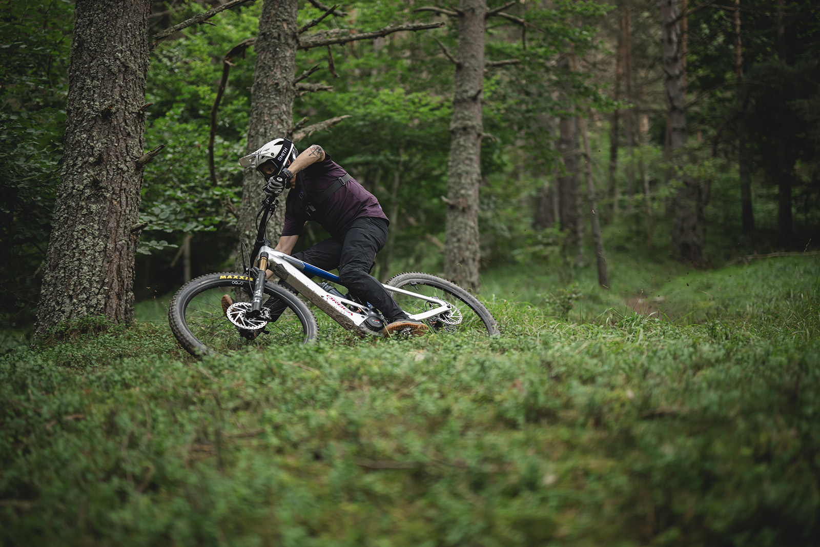 Male rider in purple top riding the Orbea Wild M-LTD Full Suspension Mountain eBike