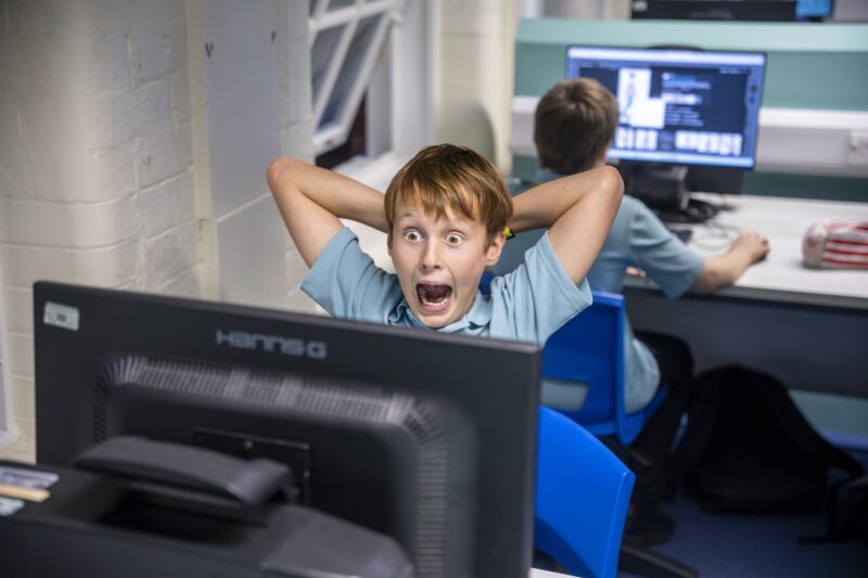 A young learners is excited about his Python project.