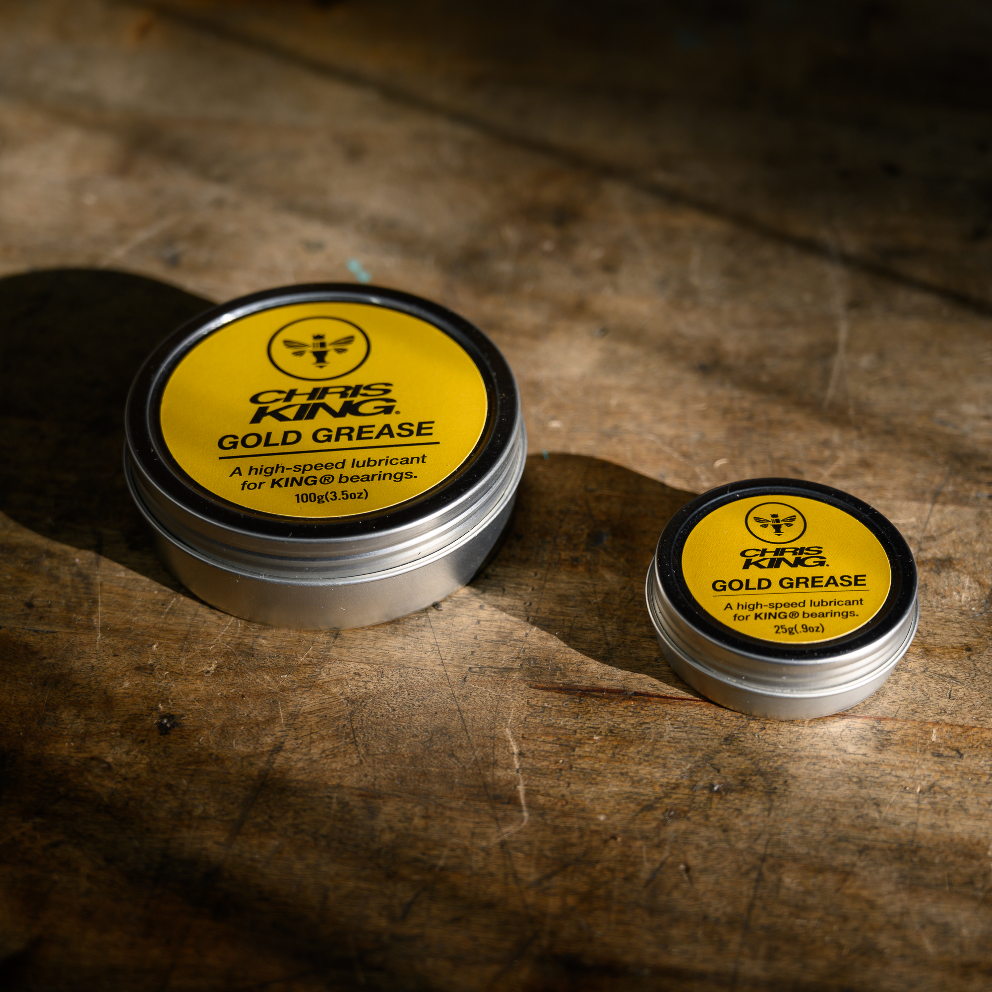Two tins of Chris King Gold Grease.