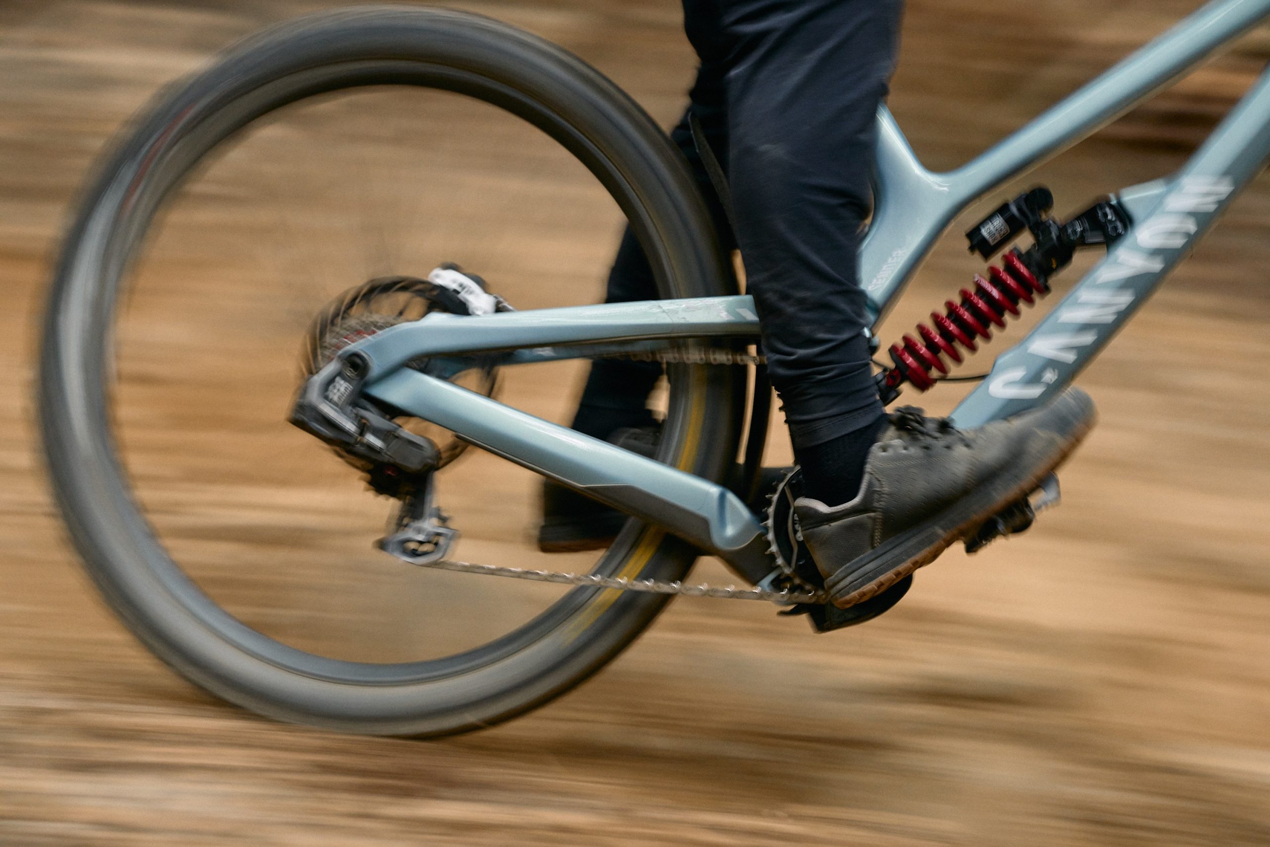 SRAM XX DH Transmission side on shot showing rider's feet and back half of the bike, focusing on the drivetrain.