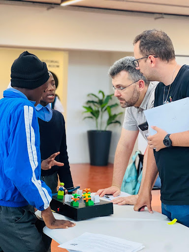 A group of people standing around a table.
