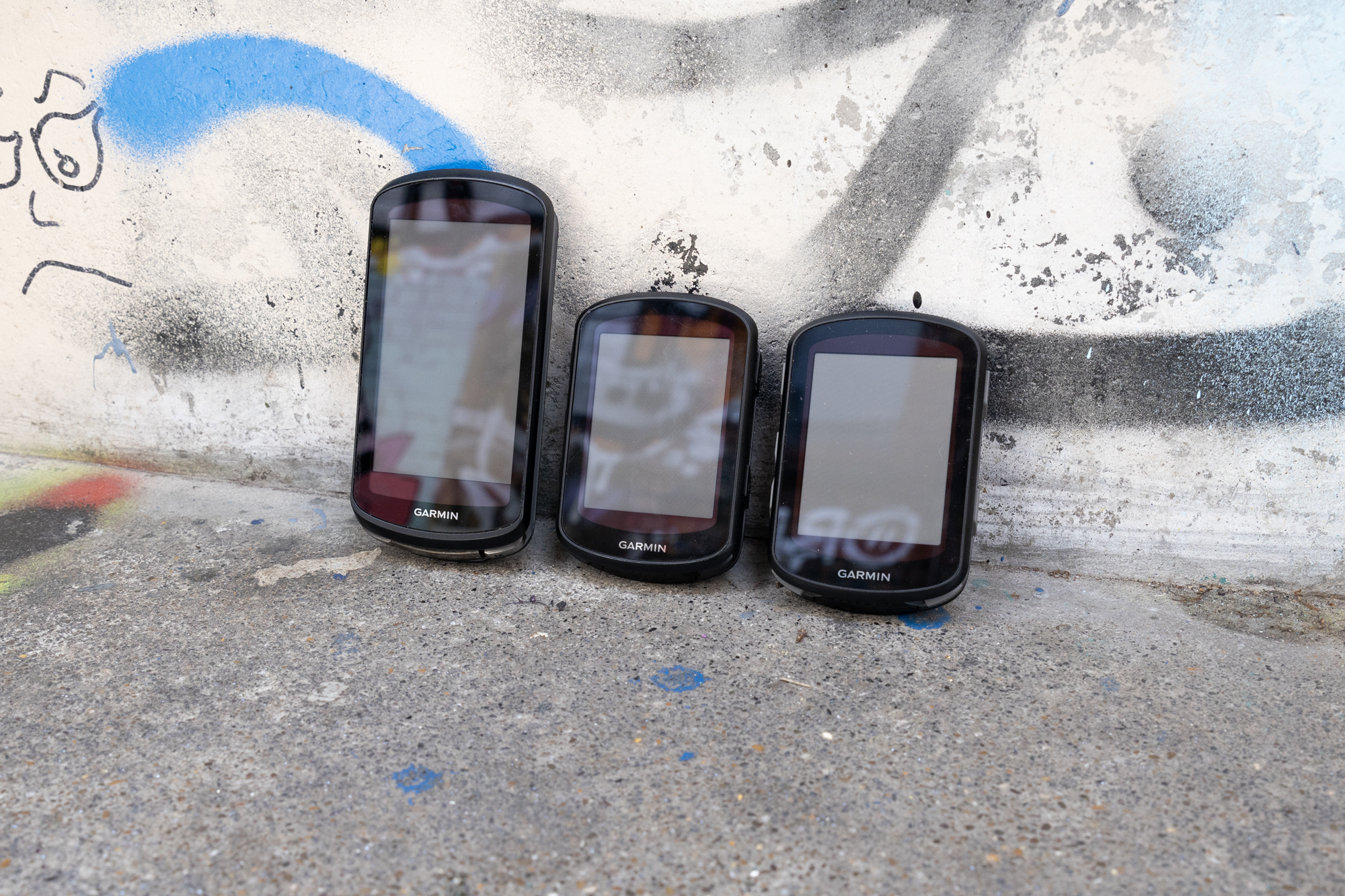 Garmin Edge 840 Solar, Garmin Edge 1040 Solar and Garmin Edge 540 Solar lined up on step.