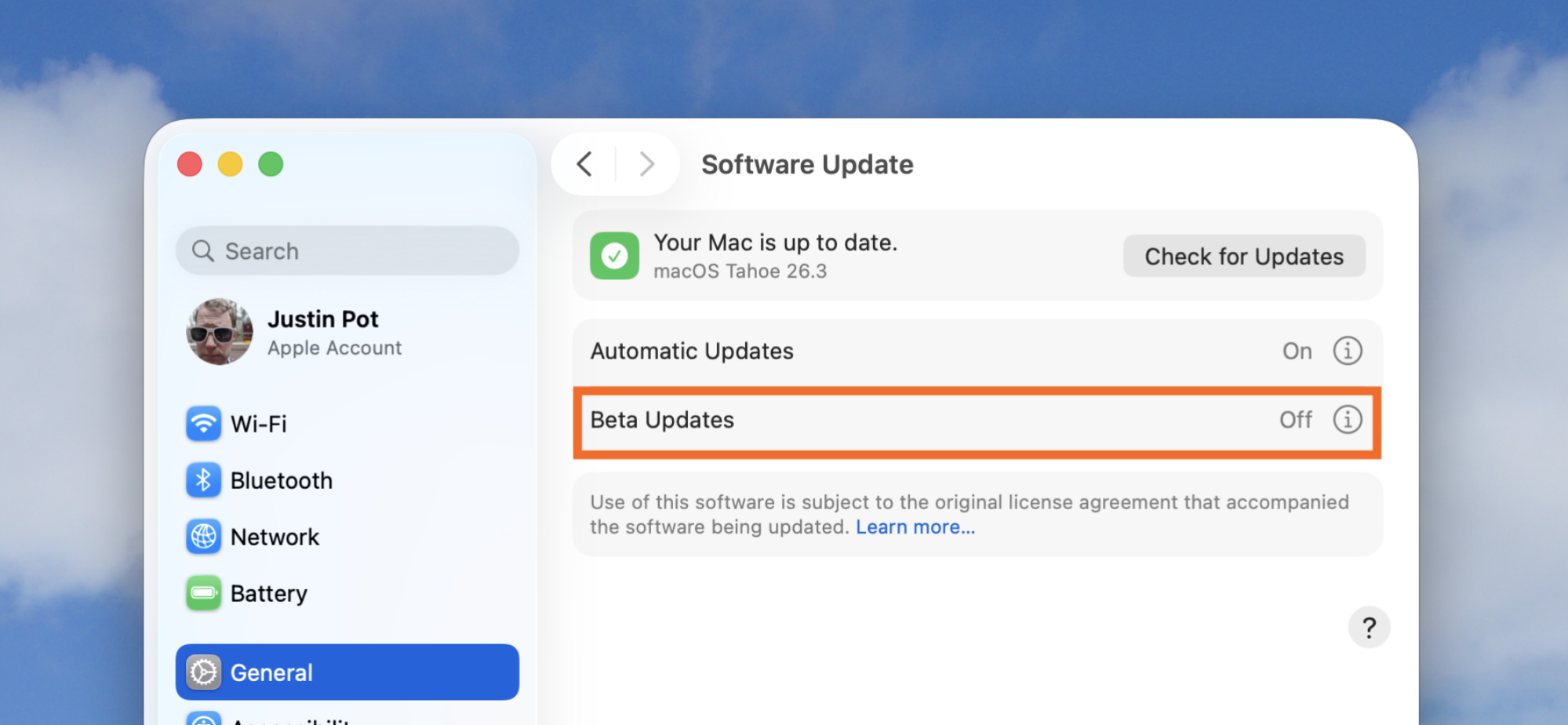 The macOS settings app, opened to the updates screen. The beta option is highlighted with an orange box.